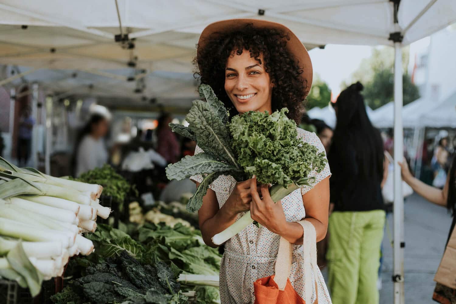 A woman holding produce at Piedmont Park's Green Market