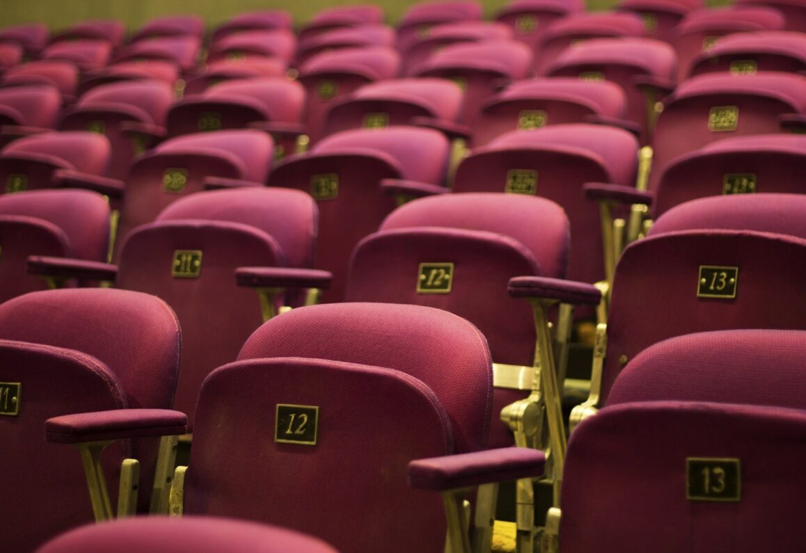 red theater seats with gold numbers and gold accents